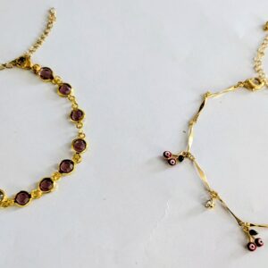 Gold bracelets with purple gemstone accents