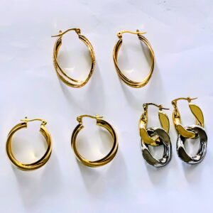 Gold and silver hoop earrings on white